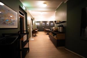 a long hallway with tables and chairs in a restaurant at Vik Tröll Hotel in Vík +35 photos