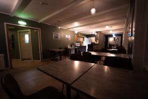 a restaurant with tables and chairs in a room at Vik Tröll Hotel in Vík