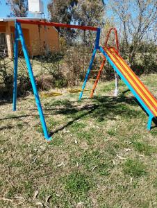 a group of colorful swings in a park at Cabañas Universo in San Rafael