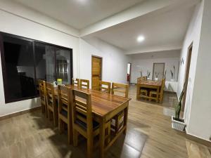 a dining room with a wooden table and chairs at Drukinn gaireykhet homestay in Thode +43 photos