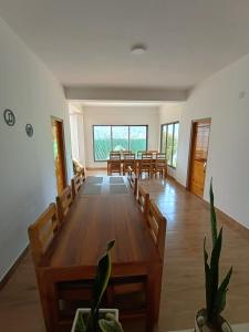 a dining room with wooden tables and chairs at Drukinn gaireykhet homestay in Thode