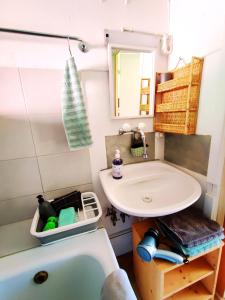 a small bathroom with a sink and a tub at Romantic Alpine Farmhouse with Superview of Lake Near Interlaken in Sundlauenen +45 photos