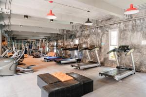 a gym with a bunch of exercise equipment in a room at Replay R6 Pool Villa in Bophut
