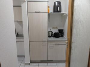 a kitchen with a refrigerator and a microwave at Wohnung am Tor zur Lewitz-Erdgeschoss in Banzkow