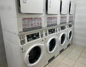 a row of washing machines in a laundry room at modern apartment excellent location coquimbo in Coquimbo +5 photos