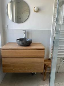 a bathroom with a sink and a mirror on a dresser at Maison proche plage avec parking in Wimereux +13 photos