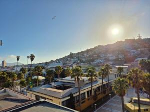 a view of a city with palm trees and a mountain at modern apartment excellent location coquimbo in Coquimbo