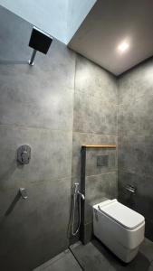 a bathroom with a toilet and a shower stall at Backwater Brook in Kumarakom