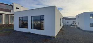 a white building with large windows on the side of it at Palacio Eco in Tinajo