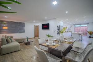 a large living room with a table and chairs at The Andes apartment Patio & Luxury in Cuenca