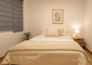 a bedroom with a large bed with a window at The Andes apartment Patio & Luxury in Cuenca +34 photos