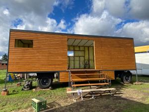 a tiny house on the back of a truck at Útulná maringotka v srdci Šumavy in Borová Lada