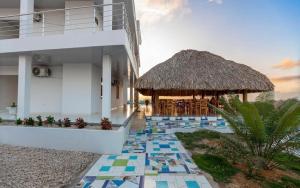 a view of a resort with a thatch roof at Hotel mirador Dubai in San Antero