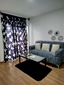 a living room with a couch and a table at EDIFICIO REY NIÑO in Posadas