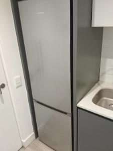 a kitchen with a refrigerator next to a sink at 1 on albert Luxury apartment in Cape Town +2 photos