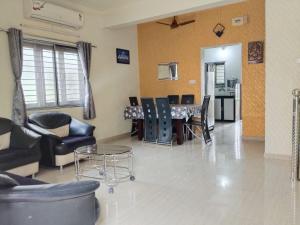 a living room with chairs and a table in it at Ram Niwas Villa 3 Bedroom Home in Vadodara