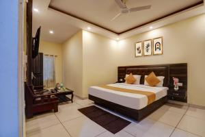 a bedroom with a bed and a television in it at Hotel City Lite Near Delhi International Airport in New Delhi