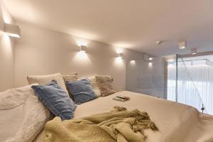 a bedroom with a bed with a blanket on it at Solmare Luxury Apartment in Świnoujście
