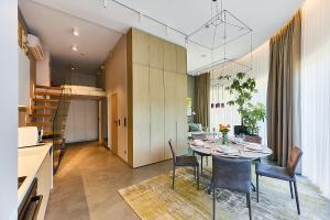 a kitchen and dining room with a table and chairs at Solmare Luxury Apartment in Świnoujście