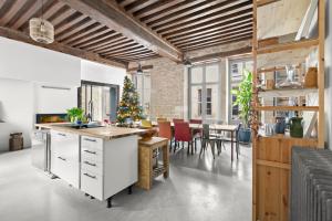 an open kitchen and dining room with a christmas tree at The Purple Courtyard in Beaune