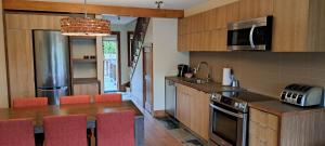 a kitchen with a counter top and a stove top oven at Le Grand R in Saint-Donat-de-Montcalm +9 photos