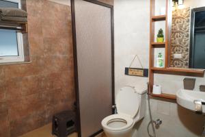 a bathroom with a toilet and a sink at 2Bhk Home By Da Alohas Mukhteshwar in Mukteswar +21 photos