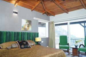 a bedroom with a large bed and a green curtain at 2Bhk Home By Da Alohas Mukhteshwar in Mukteswar