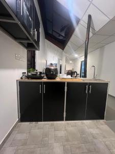 a kitchen with black cabinets and a sink at Villa Eco Stay in Tangalle +78 photos