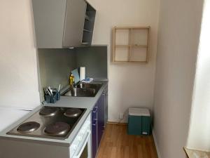 a small kitchen with a sink and a stove at Gemütliches Apartment in Osnabrück in Osnabrück