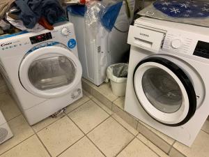 a washing machine and a washer in a laundry room at Gemütliches Apartment in Osnabrück in Osnabrück