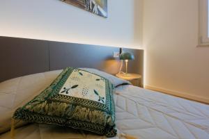 a bedroom with a bed with a pillow on it at Camera Denver - La Casa di Carta Affittacamere in Udine