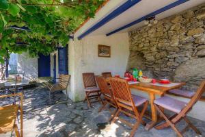 une table et des chaises en bois sur une terrasse dans l'établissement Maison entre mer et montagne, à Santa-Reparata-di-Moriani