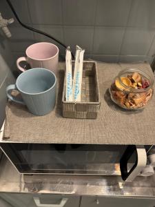 a table with two cups and a bowl of food at BUNKA HOUSE OSAKA room d in Osaka +8 photos
