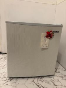 a refrigerator with a flower on top of it at BUNKA HOUSE OSAKA room d in Osaka