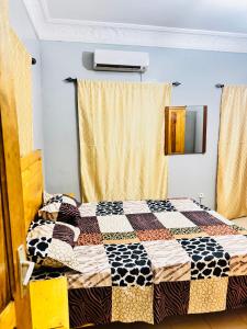 a bedroom with a bed with a quilt on it at Thurin imo nord STUDIO in Saint-Louis