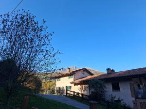 a white building with a fence next to a house at Le Notti Magiche in Occhieppo Superiore +5 photos