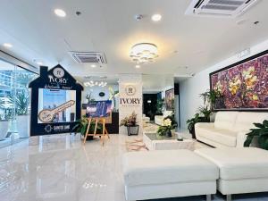 a living room with a couch and a tv at One Bedroom Unit - Ivory Residences Near DMSF Medical School & Abreeza Mall in Davao City