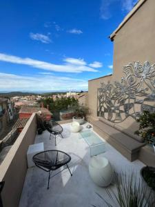 a patio with two chairs and a table on a balcony at Begur, mon amour in Begur +46 photos