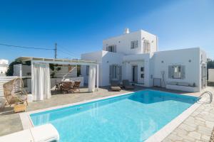 a villa with a swimming pool in front of a house at Sunny Villa Sifnos in Apollonia