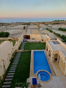 an aerial view of a house with a swimming pool at iteru inn in Tunis