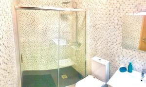 a bathroom with a shower and a toilet and a sink at Azurara Martins House in Azurara +7 photos