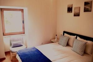 a bedroom with a large bed and a window at Azurara Martins House in Azurara