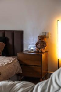 a teddy bear sitting on a table in a bedroom at Bae Villa Đà Lạt in Da Lat
