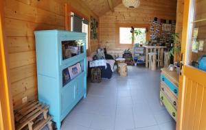 a kitchen with a blue cabinet in a room at Chalet L' Aventurière in Masevaux