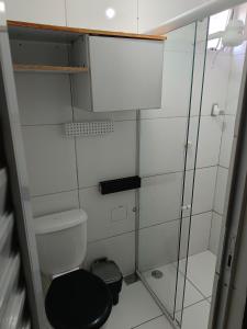 a bathroom with a toilet and a glass shower at Casa da isy hospedagem in Natal +54 photos