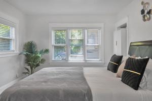 a white bedroom with a large bed with pillows at Spacious 4 Bed Home - In-Law Unit -Near SF and Napa in Vallejo