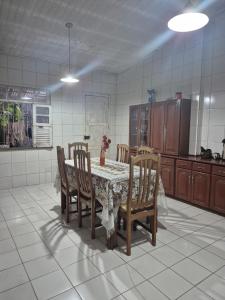 a kitchen with a table and some chairs and a table at Casa em Belém cop 30 in Belém