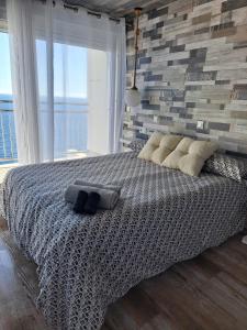 a bedroom with a large bed with a large window at Blue Horizon in Almería +12 photos