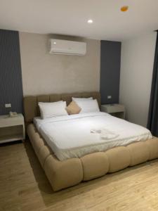 a bedroom with a large bed with white sheets and pillows at pyramids heaven inn in Giza