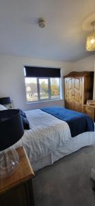 a bedroom with a large bed and a window at The Willows in Stockton-on-Tees +4 photos